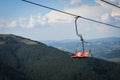 Empty chairlift on a background of beautiful autumn mountains Royalty Free Stock Photo