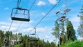 Empty chairlift cabins during off-season. The ski lift is closed in summer. The deserted ski complex is empty in the summer Royalty Free Stock Photo