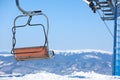 Empty chairlift at mountain ski resort, space for text. Winter vacation Royalty Free Stock Photo