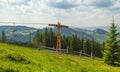 Empty chairlift in ski resort with green grass and blue sky Royalty Free Stock Photo