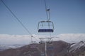 Empty Chairlifts in Ski Resort and Snowy Mountain in Background