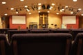 Empty chairs facing cross and worship stage in church Royalty Free Stock Photo