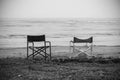 Empty chairs in front of sea