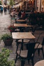 Empty chairs in outdoor cafe or restaurant on summer day. Reastaurant tables waiting for customers, old town Royalty Free Stock Photo