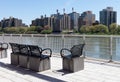 Empty Chairs at a Park on the Upper East Side with a view of the Roosevelt Island Skyline along the East River in New York City
