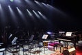 Empty chairs stand on stage in Concert Hall. Piano on stage. Scene symphony concert hall.European scene, a concert of symphonic m Royalty Free Stock Photo