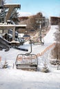 Empty chairs at station of ski-lift chair at resort Snowland Valca in winter season Royalty Free Stock Photo