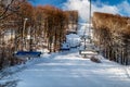 Empty chairs at station of ski-lift chair at resort Snowland Valca in winter season Royalty Free Stock Photo