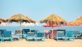 Empty chairs under thatched umbrellas on a sandy beach in Goa Royalty Free Stock Photo