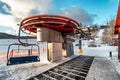 Empty chairs at vottom station of ski-lift chair at resort Snowland Valca in winter season Royalty Free Stock Photo