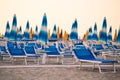 Empty chaise-longue with beach umbrellas