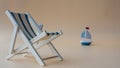 An empty chaise longue and a boat on the horizon. Summer concept, tourism, pandemic, coronavirus, copy space Royalty Free Stock Photo