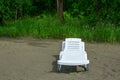 Empty chaise lounge on the sand Royalty Free Stock Photo