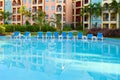 Empty chaise lounges near pool