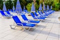 Empty chaise lounges and sun umbrellas near the swimming pool Royalty Free Stock Photo