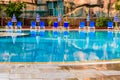 Empty chaise lounges and sun umbrellas near the swimming pool Royalty Free Stock Photo