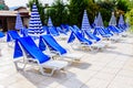 Empty chaise lounges and sun umbrellas near the swimming pool Royalty Free Stock Photo