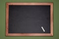 Empty chalk board with wooden frame on green background, blank copy space Royalty Free Stock Photo