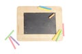Empty chalkboard for copy space with colorful pieces of chalk on white background