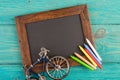 empty chalkboard with copyspace and colorful crayons on wooden table Royalty Free Stock Photo