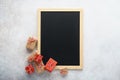 Empty chalkboard and gift boxes on light gray background