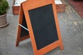 Empty chalkboard mockup next to a shop, restaurant or coffee shop Royalty Free Stock Photo