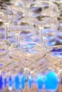 empty champagne glasses in pyramid or tower on table at wedding reception, alcohol bar, catering in restaurant. Royalty Free Stock Photo