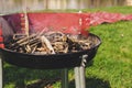 Empty charcoal grill with smoke closeup. Barbecue outdoor.