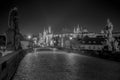 Empty Charles Bridge in the center of Prague during first wave of Covid-19 pandemy in the night with blue sky and yello