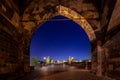 Empty Charles Bridge in the center of Prague during first wave of Covid-19 pandemy in the night with blue sky and yello