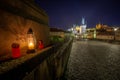 Empty Charles Bridge in the center of Prague during first wave of Covid-19 pandemy in the night with blue sky and yello