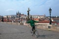 Empty Charles bridge in Prague and lonely cyclist