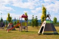 Empty children play park with slides and teepee tents Royalty Free Stock Photo