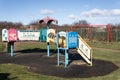 Empty childs playground in enclosed park area in residential area.  Various climbing frames and structures visible Royalty Free Stock Photo