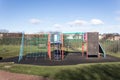 Empty childs playground in enclosed park area in residential area.  Various climbing frames and structures visible Royalty Free Stock Photo