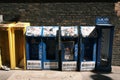 Empty Chinese newspaper stands with graffiti and stickers on the street in Chinatown