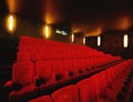 Empty cinema or movie theatre with row of red seats at night before a movie or film theater interior room. Chair in a Royalty Free Stock Photo