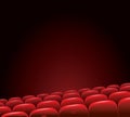 Empty cinema with red seats on a dark background