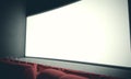 Empty cinema screen with red seats. With color filter. 3d render Royalty Free Stock Photo