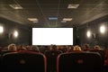 Empty cinema seats with blank white screen