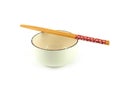 Empty circle beige ceramic bowl with brown rim and white small pattern, chopsticks isolated on a white background. Royalty Free Stock Photo