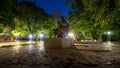 Empty city park landscape at the late evening or night with lit lightposts