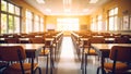 Empty classroom interior with rows of desks and chairs bathed in sunlight Royalty Free Stock Photo