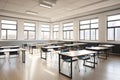 empty classroom with large windows, natural light streaming in