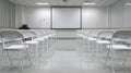 Empty Classroom with Projector Screen and Rows of Chairs Ready for Learning Royalty Free Stock Photo