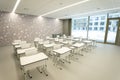 Empty classroom in school or university - chairs and desks without anyone. All room in white colour Royalty Free Stock Photo