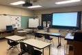 empty classroom setup with smartboard, projector, and laptop for modern learning Royalty Free Stock Photo