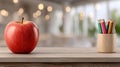 An empty classroom shows an apple and colored pencils on the desk. The space invites thoughts of learning and creativity Royalty Free Stock Photo