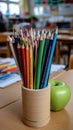 An empty classroom shows an apple and colored pencils on the desk. The space invites thoughts of learning and creativity Royalty Free Stock Photo