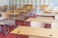 Empty classroom with wooden desks and chairs